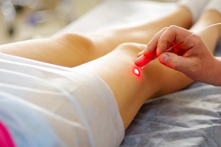 Clinician using a small light-emitting instrument during a procedure